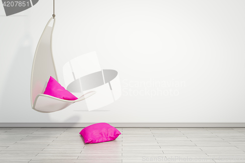 Image of hanging armchair with pink pillows
