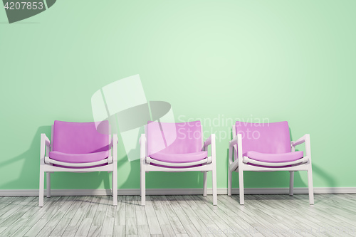 Image of armchairs green wall
