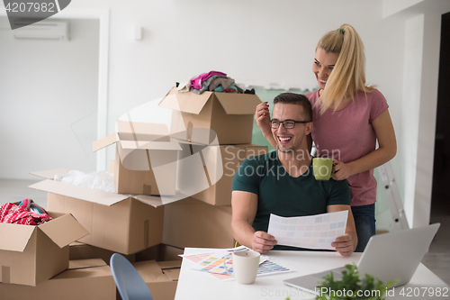 Image of Young couple moving in a new home