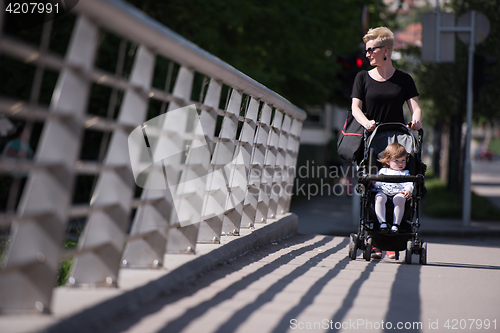 Image of mother pushed her baby daughter in a stroller