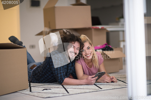 Image of Young couple moving in a new flat