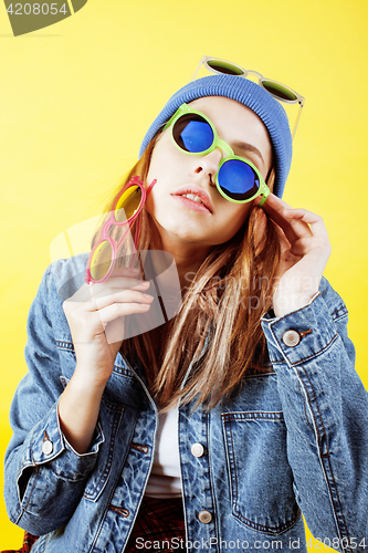Image of young pretty long hair teenage hipster girl posing emotional happy smiling on yellow background, lifestyle people concept