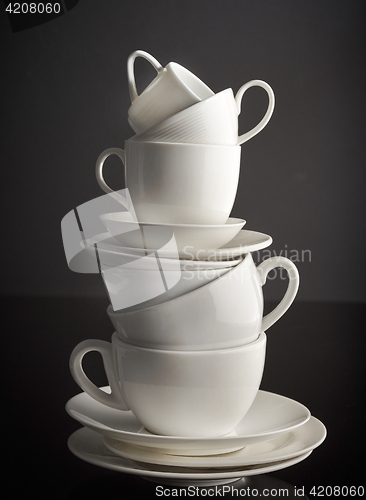 Image of stack of white coffee cups and plates