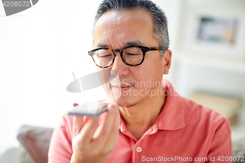 Image of man using voice command recorder on smartphone