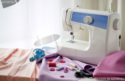 Image of sewing machine, scissors, buttons and fabric