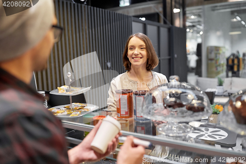 Image of woman and man or barman with coffee cup at cafe