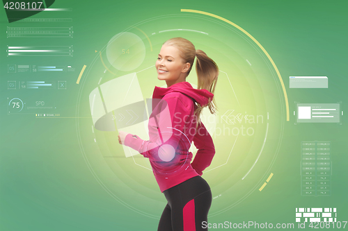 Image of smiling young woman running over green