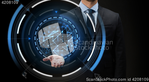 Image of businessman with virtual projection over black