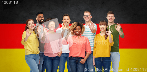 Image of international people showing ok over german flag