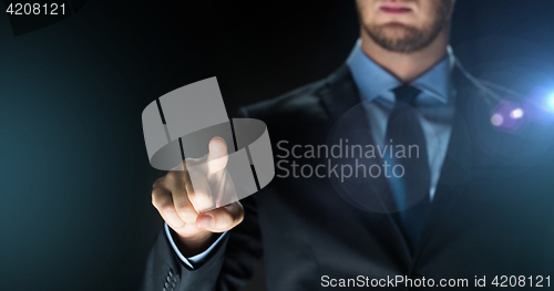 Image of businessman touching something imaginary