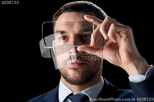 Image of businessman with transparent smartphone