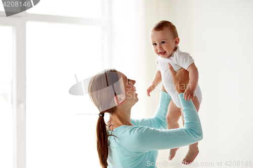 Image of happy young mother with little baby at home