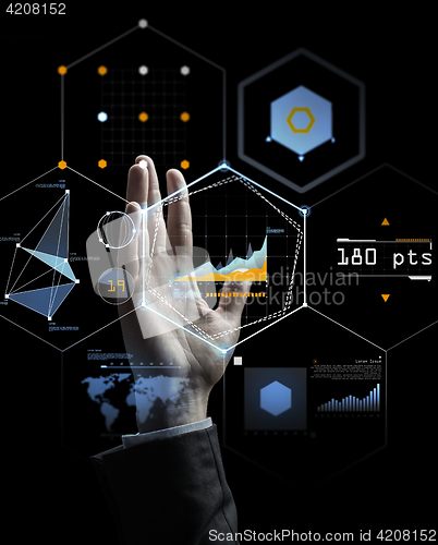 Image of businessman hand with virtual charts over black