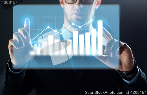 Image of close up of businessman touching virtual chart