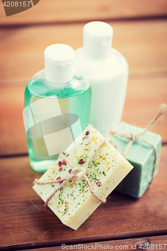 Image of close up of handmade soap bars and lotions on wood