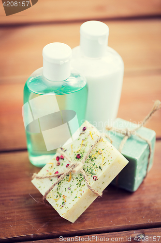 Image of close up of handmade soap bars and lotions on wood