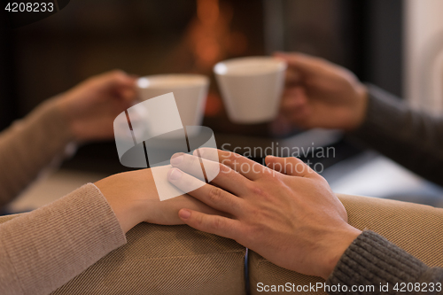 Image of Young couple  in front of fireplace