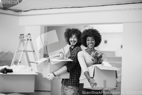 Image of multiethnic couple moving into a new home