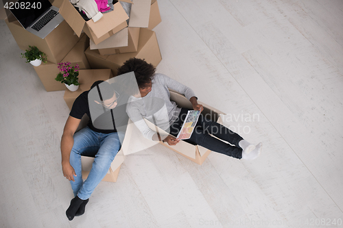 Image of African American couple  playing with packing material