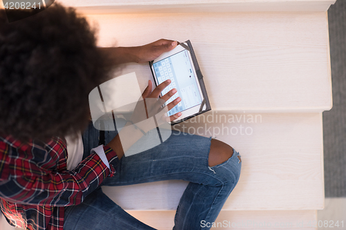 Image of black woman using her electronic tablet