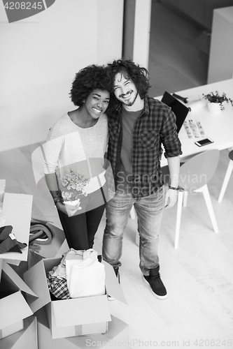 Image of multiethnic couple moving into a new home