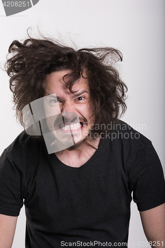 Image of Portrait of a man in party hat blowing in whistle