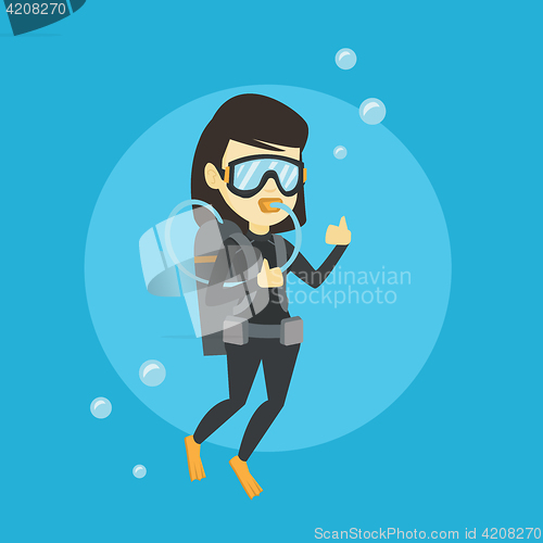 Image of Woman diving with scuba and showing ok sign.