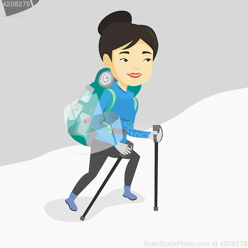 Image of Young mountaneer climbing a snowy ridge.