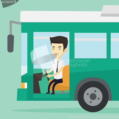 Image of Asian bus driver sitting at steering wheel.