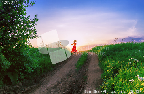 Image of Young Woman Dancing Against The Setting Sun