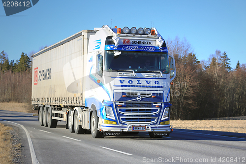 Image of Blue and White Volvo FH Semi Truck Transport at Spring