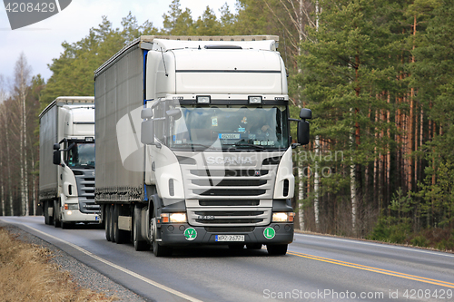 Image of Two White Scania R420 Semi Trailer Trucks on the Road