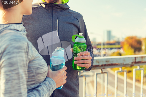 Image of close up of couple with water bottles outdoors