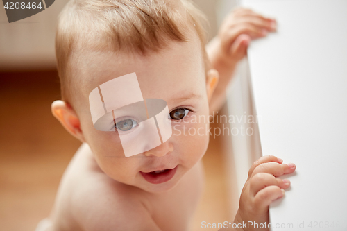 Image of happy little baby boy or girl at home