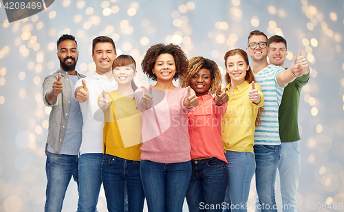 Image of international group of people showing thumbs up