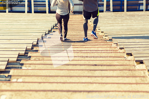 Image of close up of couple running downstairs on stadium