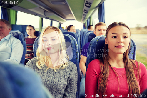 Image of happy young women riding in travel bus