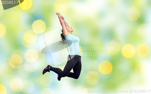 Image of happy smiling sporty young woman jumping in air