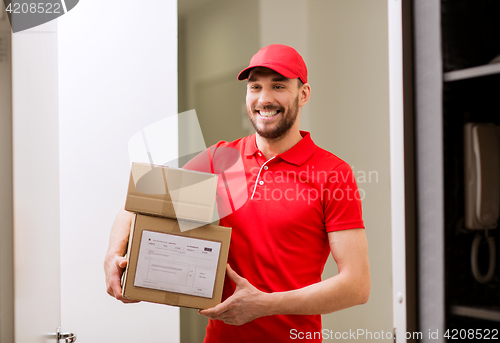 Image of delivery man with parcel boxes at customer door