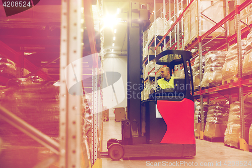 Image of man on forklift loading cargo at warehouse