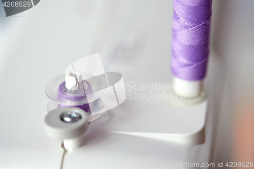 Image of thread spools on sewing machine