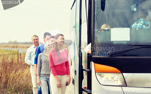 Image of group of happy passengers boarding travel bus