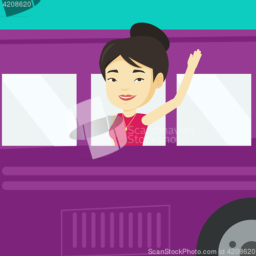 Image of Woman waving hand from bus window.