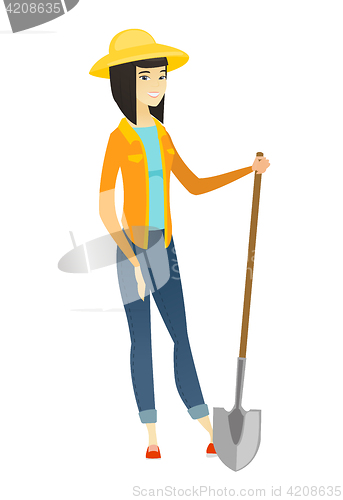 Image of Young asian farmer holding a shovel.