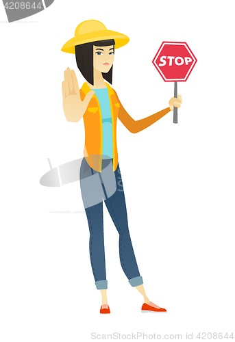 Image of Asian farmer holding stop road sign.