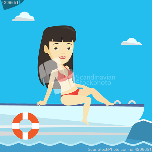 Image of Young happy woman tanning on sailboat.