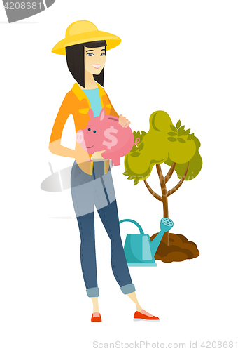 Image of Asian farmer holding a piggy bank.