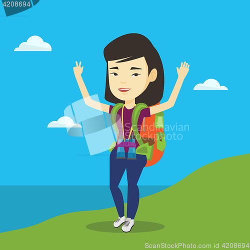 Image of Backpacker with her hands up enjoying the scenery.