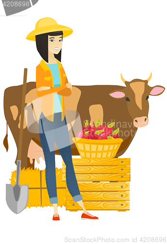 Image of Farmer standing with crossed arms near cow.