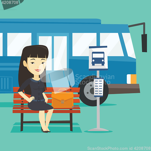 Image of Business woman waiting at the bus stop.